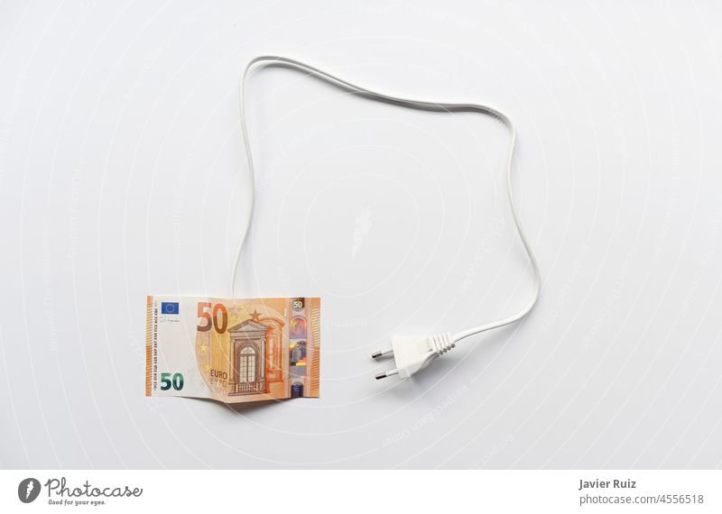 a fifty Euro bill with a cable and a plug on a white background, energy price problem, electricity tariffs electricity bill expensive euro money cord plugged