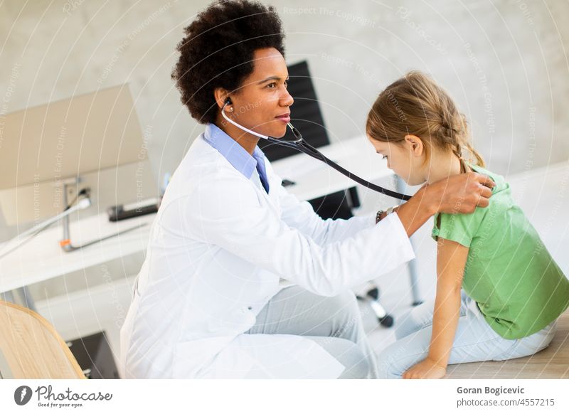 Cute little girl at the pediatrician examination african american black care checking child children clinic daughter disease doctor family female health
