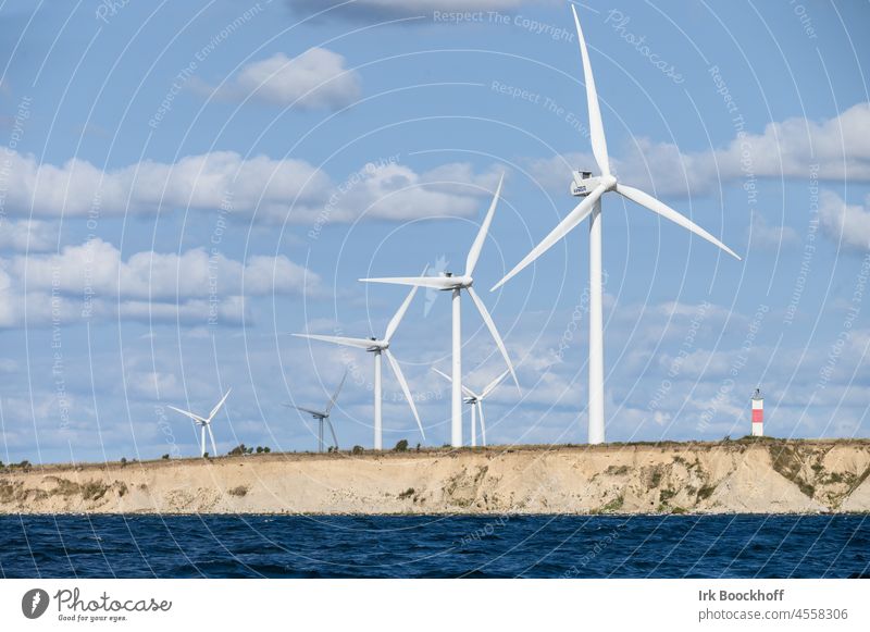 Wind farm on the coast with lighthouse Green White Blue Resource Climate change Clean Rotor Alternative Technology Ecological Eco-friendly Electricity