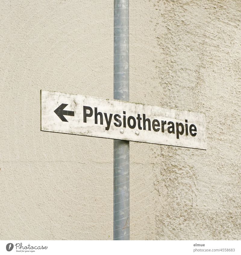 Sign with arrow and - physiotherapy - on a metal pole in front of a house / direction sign / physiotherapist Physiotherapy Arrow Metal post Building signpost