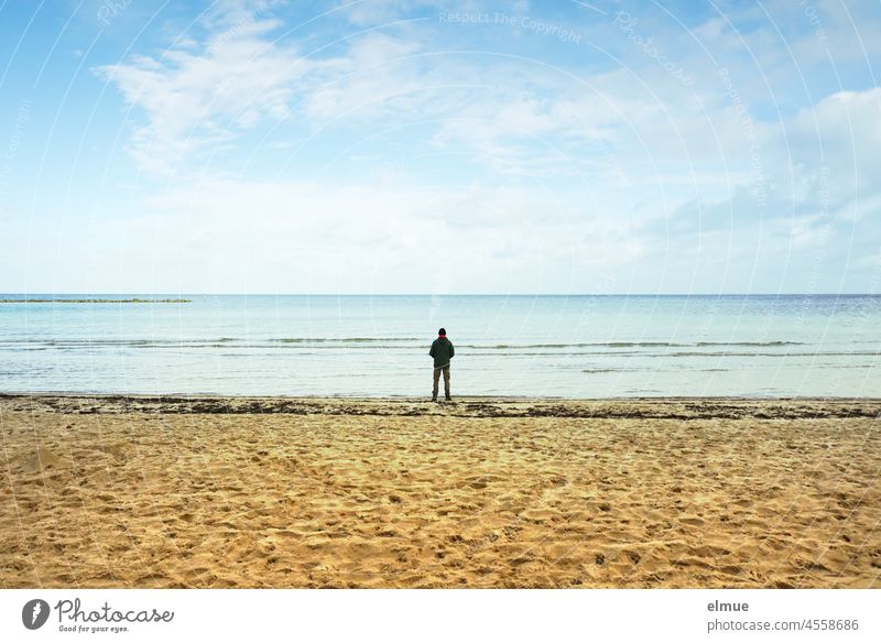 A man alone on the sandy beach, looking at the calm sea / vacation / relaxation / longing Ocean Baltic Sea Man person Sandy beach Beach bank philosophize Water