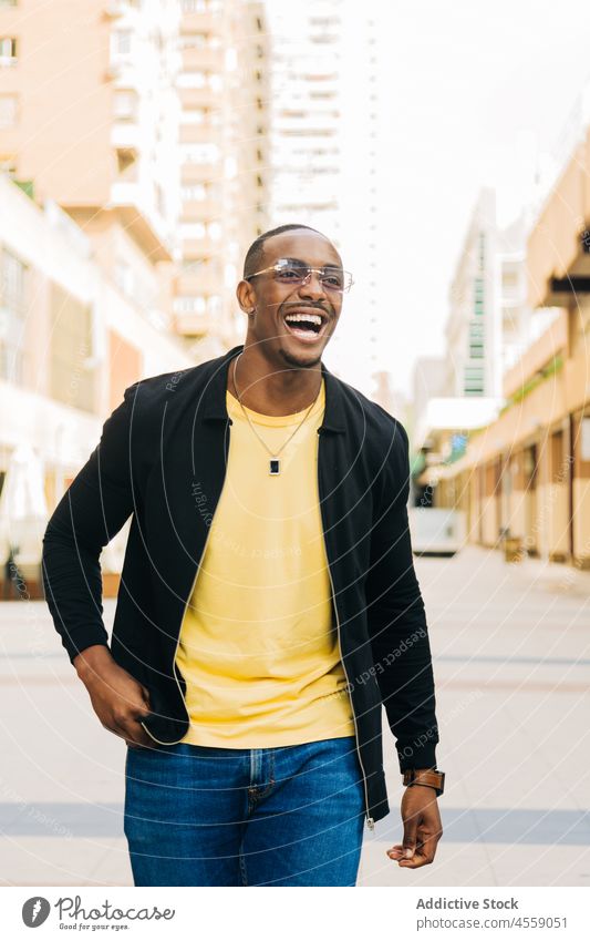 Cheerful African American guy on street man cheerful eyeglasses positive smile optimist portrait content enjoy urban city delight happy african american male