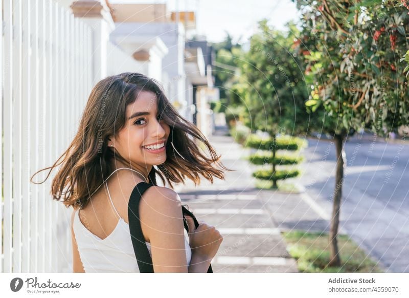 Happy lady enjoying summer day on street woman portrait content smile cheerful expressive delight positive happy pleasant female hispanic ethnic carefree