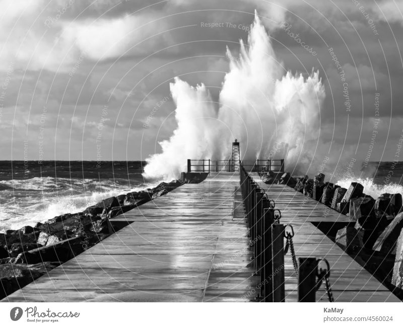 Black and white picture of the lighthouse on the pier of Nørre Vorupør during storm and high waves, Jutland, Denmark Lighthouse Gale Waves Weather Hurricane