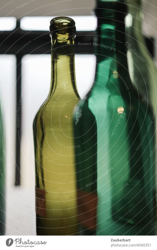 Green glass bottles in the light Glass Glass for recycling Bottle Beverage Light Detail Shallow depth of field Vine Empty empty Bottle of wine drunk up Old