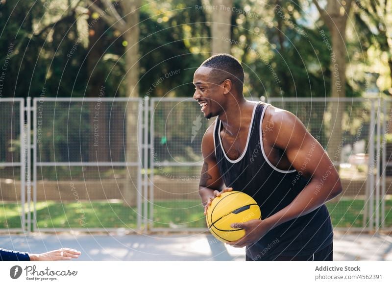 Happy black basketball player holding ball man sport training sportsman game stadium activewear sports ground motivation confident ethnic concentrate smile