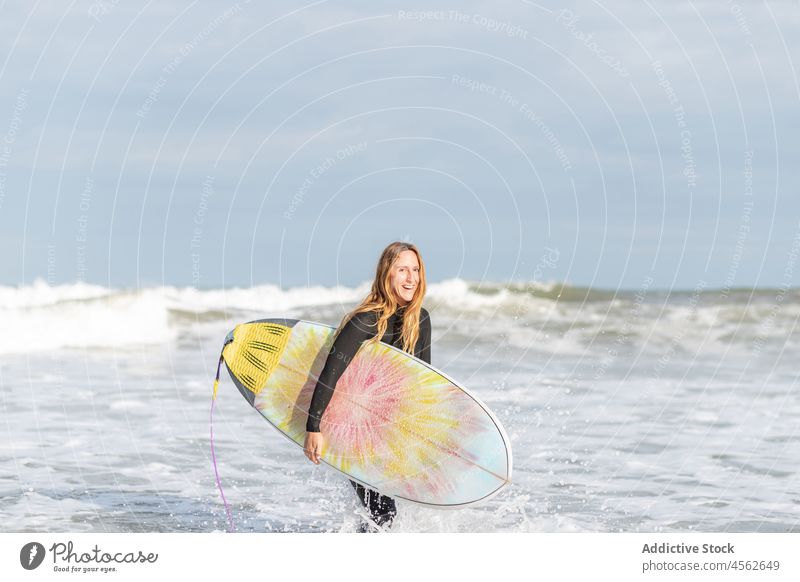 Woman portrait with surfboard in sea woman looking at camera hobby activity pastime sport water shore beach tide wave waterfront seaside nature equipment summer