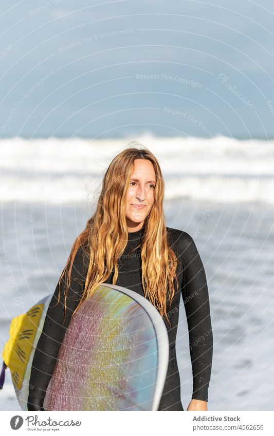 Woman with surfboard in sea woman portrait hobby activity pastime sunny sport water shore beach looking away tide wave waterfront seaside nature equipment