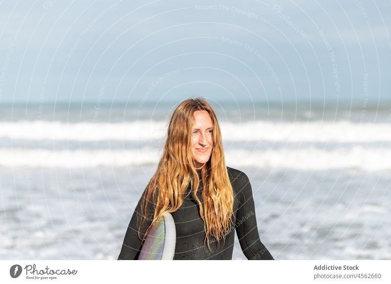 Woman portrait with surfboard in sea woman hobby activity pastime sport looking away water shore beach tide wave waterfront seaside nature equipment summer