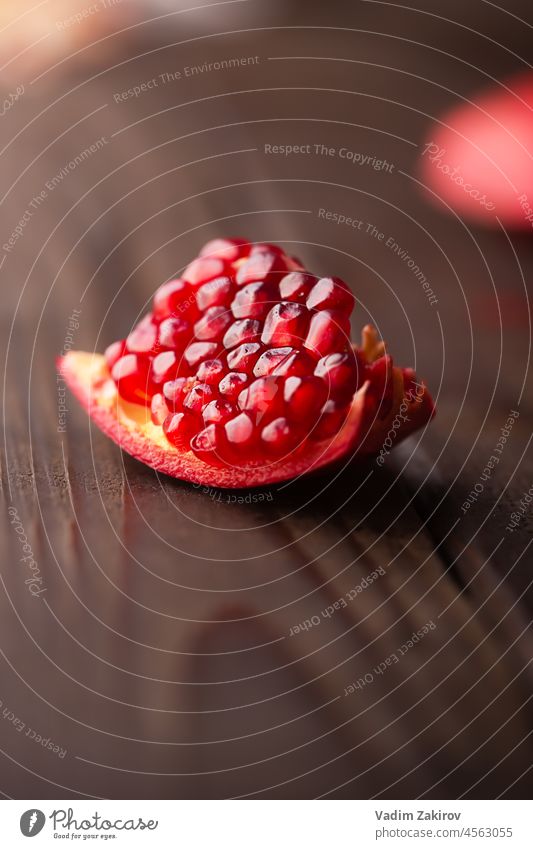 Pomegranate piece on a dark wooden table pomegranate juice selective focus fresh drink healthy minerals vitamins glass organic antioxidant fruit juicy tropical