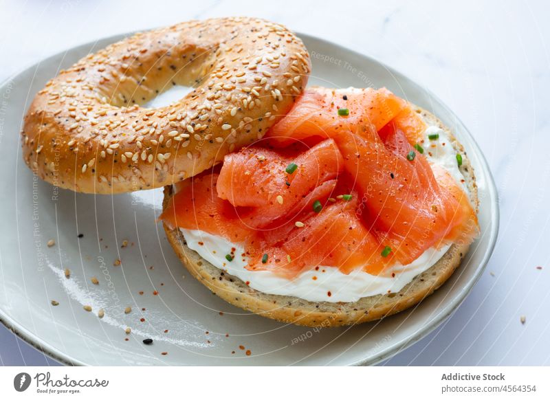 Bagel with salmon in light kitchen bagel cheese food fool breakfast bakery tasty delicious serve plate table yummy culinary appetizing gastronomy flavor fish