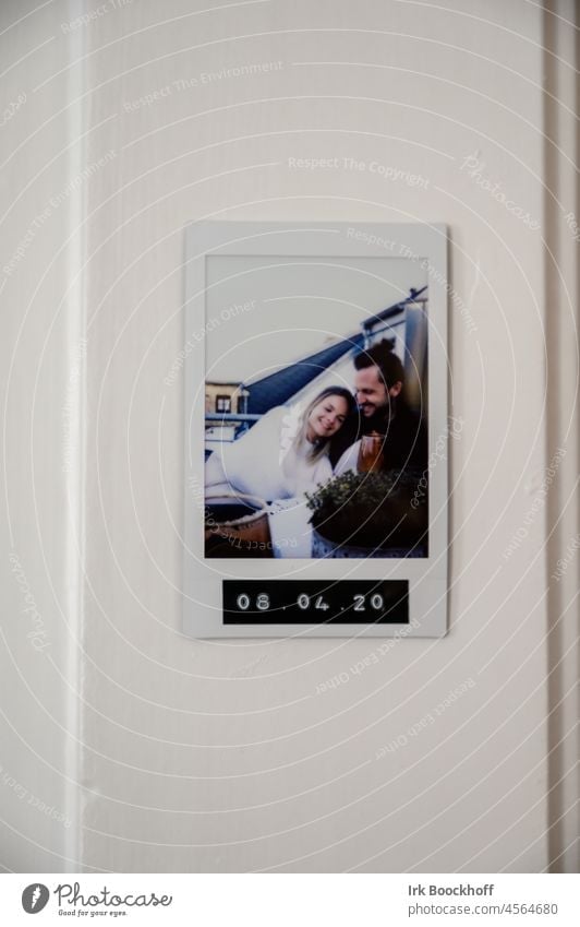 Polaroid photo of couple in love on wall with date Infatuation Related Harmonious Lovers Together Trust Affection Joy Couple Happy Young man Young woman Warmth