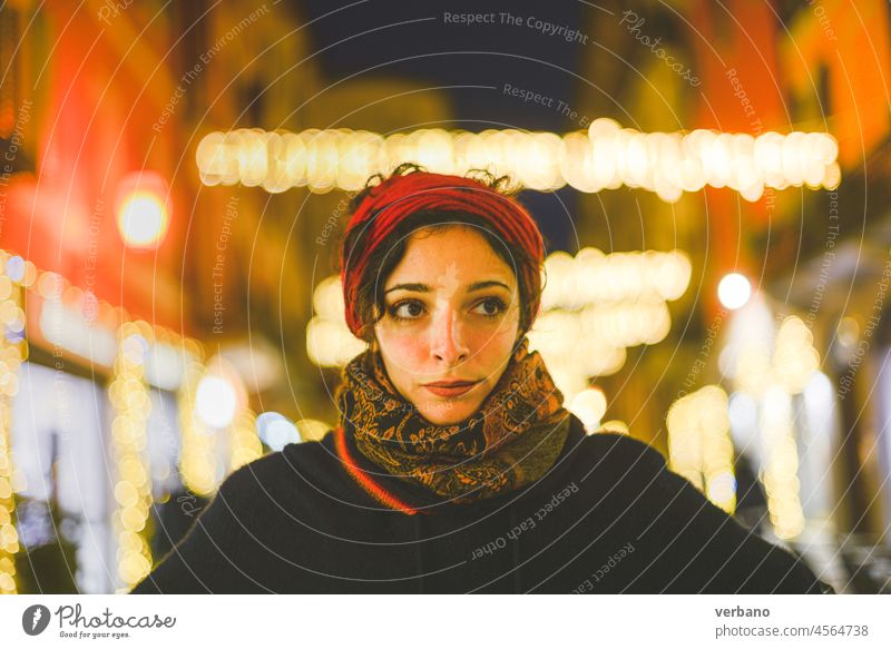 young woman and city lights during xmas beautiful girl winter street holiday person evening night outdoor happy christmas europe decoration female december