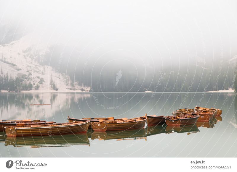 ...still and stiff rests the lake... boats Canoes Rowboats Lake Prags Wildsee Dolomites Fog mountain Lakeside silent tranquillity Grief Vacation & Travel