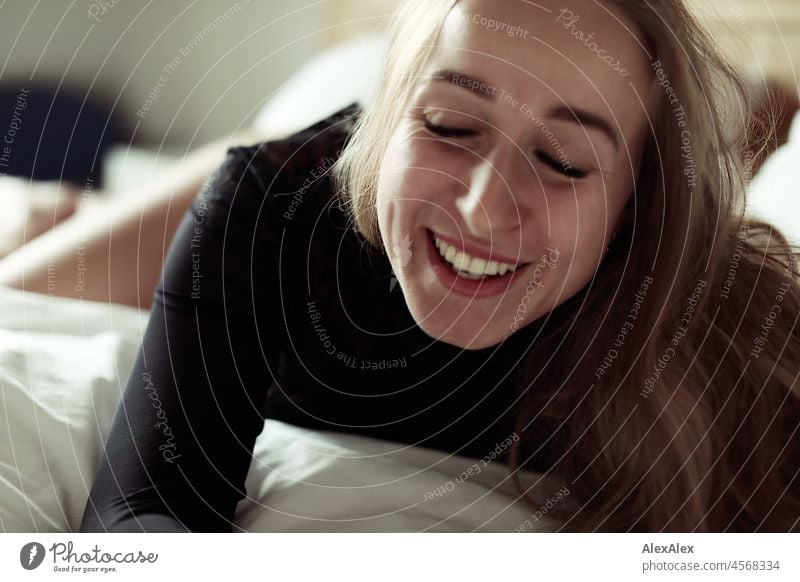 Portrait of young blonde smiling woman lying in bed Youthfulness salubriously Facial expression Warmth inside Lifestyle Long-haired senses Charming Emanation