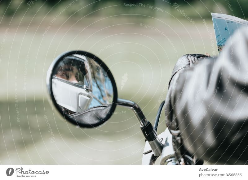 Reflection of a rearview of a motorbike man with a helmet with copy space. On route topic. Travel with safety and using protection while driving. person
