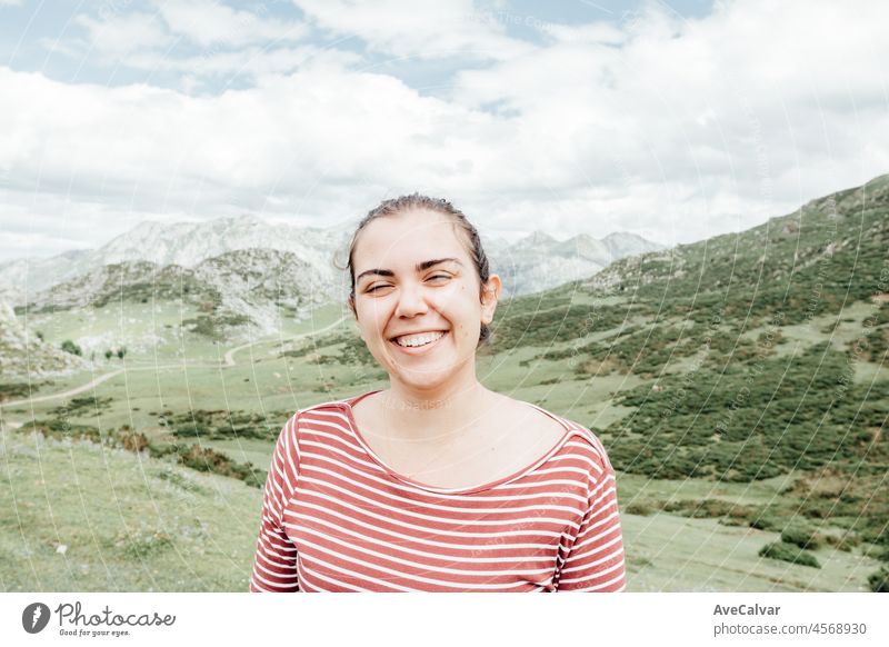 Portrait of a young woman in the Picturesque summer landscape of highland Beautiful landscape with mountains. Viewpoint panorama in Lagos de Covadonga, Picos de Europa National Park, Asturias, Spain