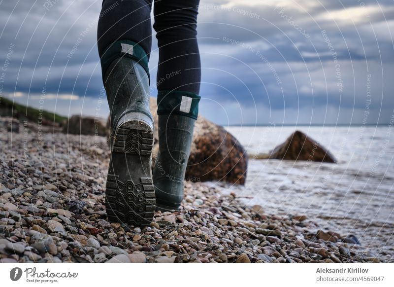 woman walks along the rocky shore of a lake hiking riverside hike trace sole lifestyle foot leg step nature freedom go sport female adventure riverbank outdoors