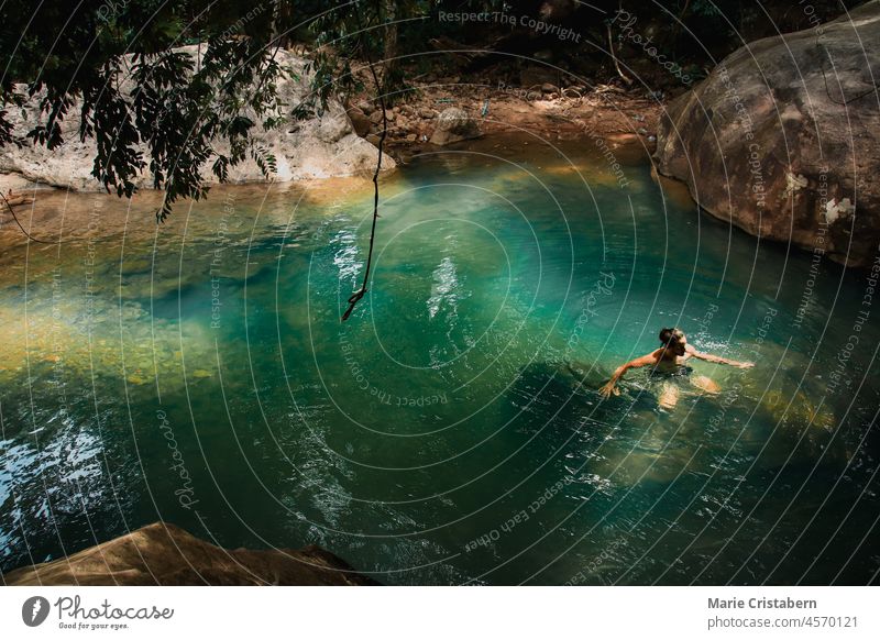High angle view of a man swimming in a natural pond in the middle of the forest one person high angle view back to nature active lifestyle outdoors
