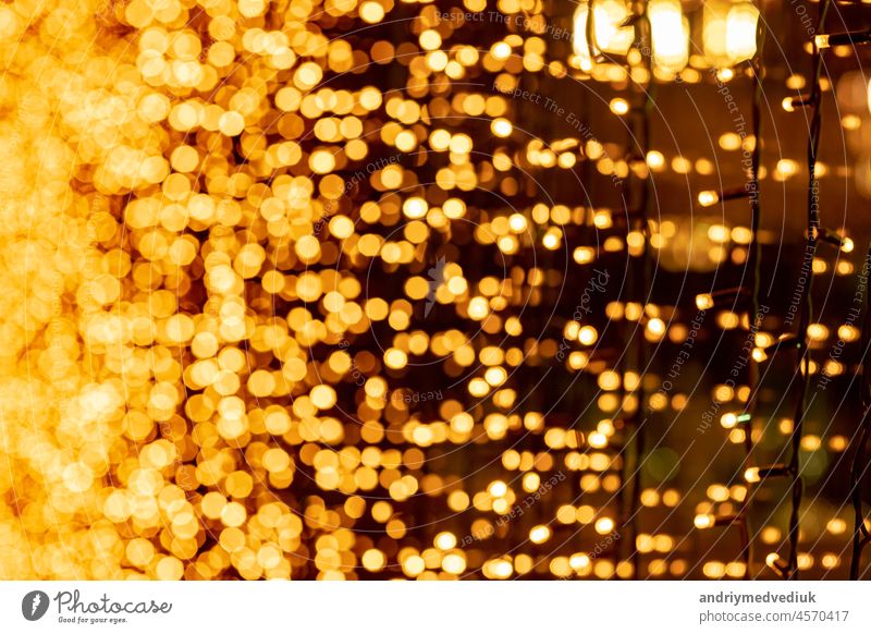 Abstract circular bokeh background of Christmaslight. bokeh from garlands. background for screensaver. Defocused lights. Blurred bokeh with yellow color lights.