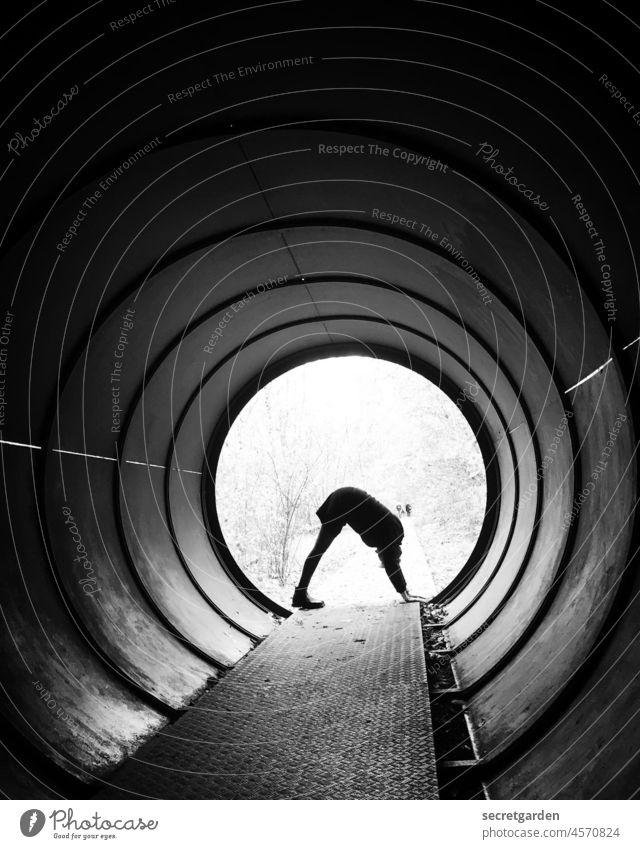 [UT Berlin 2021] Dog looking down tunnel vision conduit Passage Yoga derogatory dog Conduit Wall (building) Exterior shot Woman review Light Tunnel