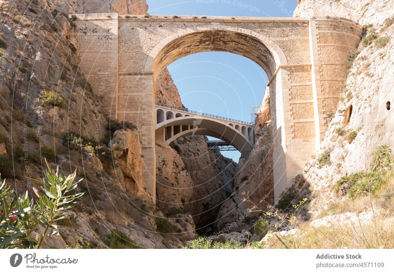 Historic bridges in nature of Calpe construction aged shabby historic mountain stone arched passage rocky old spain calpe mascarat sunlight environment scenery