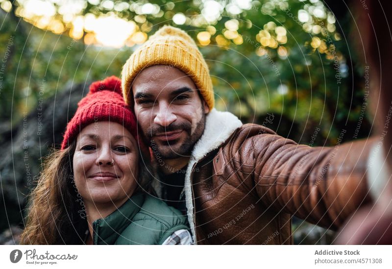 Loving couple taking selfie in nature during trip self portrait tree hipster adventure relationship hike travel together girlfriend boyfriend content grove