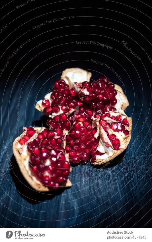 Delicious ripe pomegranate on wooden dark surface fruit fresh healthy food vitamin organic sweet delicious peel appetizing tasty red juice nutrition vegetarian
