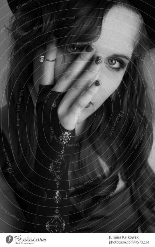 Black and white portrait of a woman with hand in front of face fashionable Lifestyle melancholically fashion photography Model Attractive Style pretty Fashion