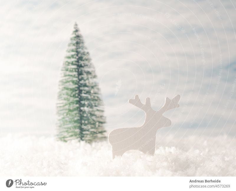 Small reindeer wooden figure in the snow with Christmas tree christmas shape december invitation landscape snowy snowflake forest greetings santa cold concept