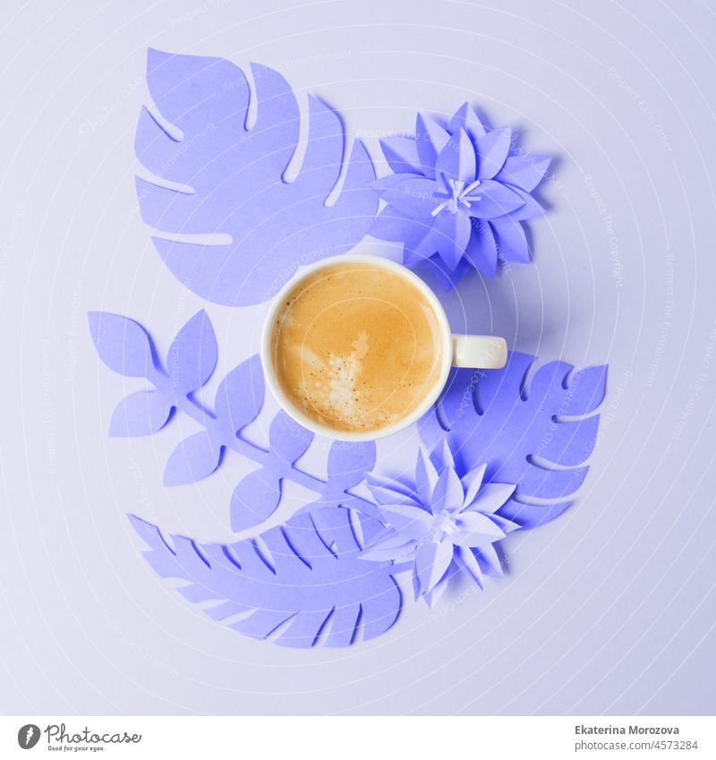Cup of coffee on papercraft ultraviolet purple flowers, origami handmade. Concept of good morning, feminine routine, trendy color of the year 2022 design