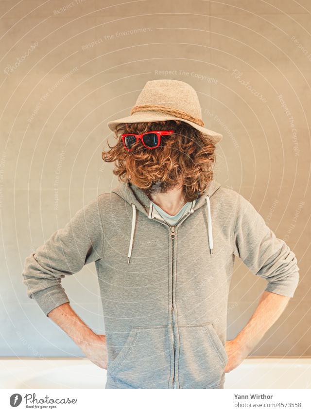 Man with hat and long curly hair on face wears red glasses Hair on the face Person wearing glasses Eyeglasses Red long hairs Facial care Face Hat Jacket Resolve