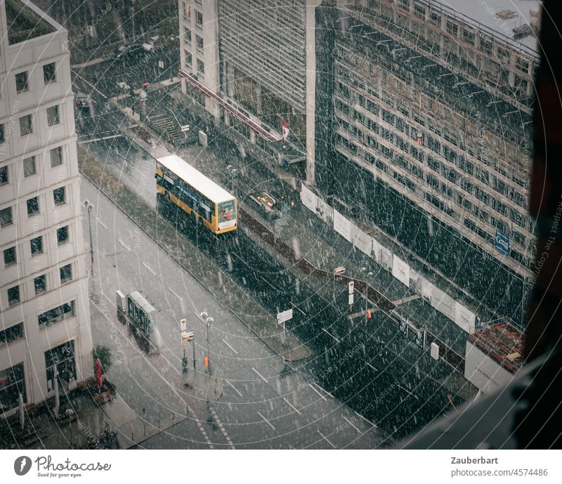 View on northern Potsdamer Platz, street from above, driving snow, yellow bus in Berlin Snow Bus cold and damp blow snow Above Yellow Public service bus Street