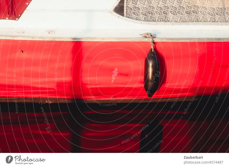 Red hull of a boat with fender fuselage Fender Water reflection Window Curtain be afloat Aquatics Sun Reflection Lake Ocean Sport boats Holiday season Sailing