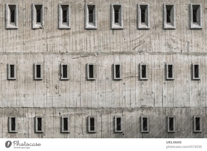 the grey facade of a bunker with many small windows looks minimalistic Window Building Architecture Dugout Manmade structures Exterior shot Deserted