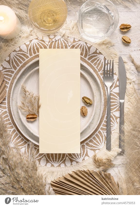 Boho Wedding Table place with vertical Blank card on plate near pampas grass bohemian paper wedding table place boho mockup tropical palm leaves dried beige