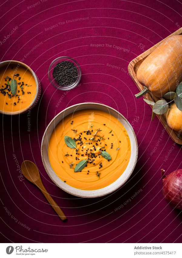 Tasty pumpkin soup placed on a plate on a table on a tabletop bowl delicious vegetable gourmet tasty cuisine food yummy spoon serve healthy food nutrition