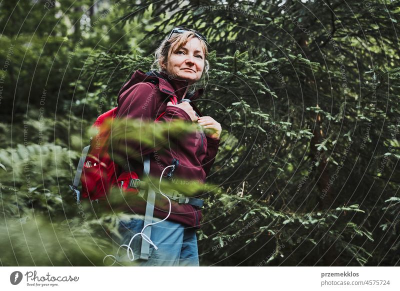 Woman with backpack hiking in forest, actively spending summer vacation close to nature adventure trip travel journey trekking woman mountain wanderlust walking