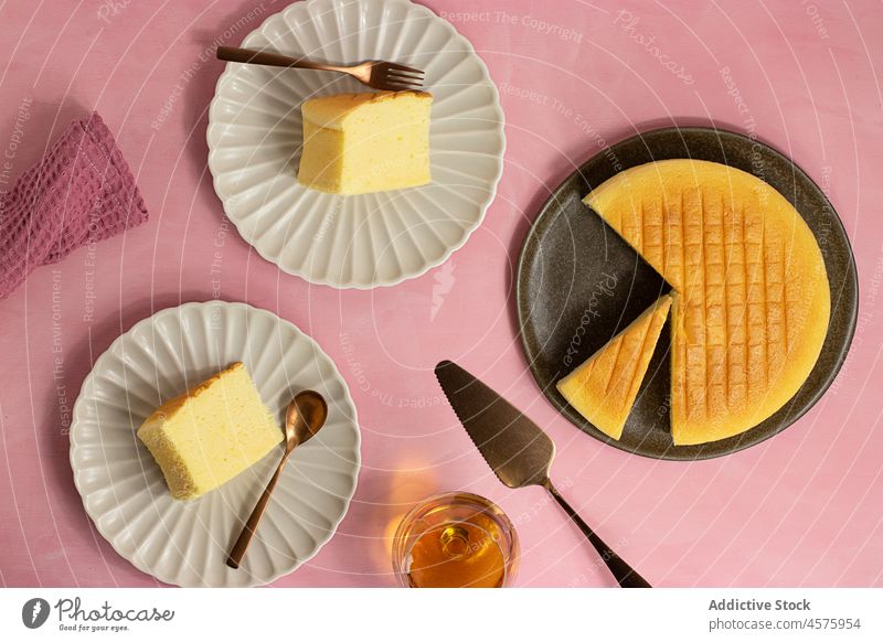 Tasty Japanese cheesecake served on plates whole cake japanese cheese cake dessert portion food pastry dish colorful bright spatula fork cotton palatable piece