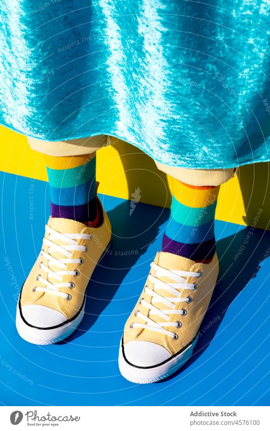 Unrecognizable person in socks with LGBT colors rainbow lgbt homosexual equal liberty tolerance human rights unconventional pride concept lgbtq sneakers leg