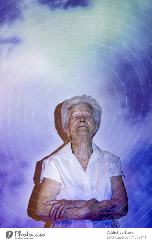 Peaceful senior woman at wall with clouds heaven elderly concept death calm peace faith peaceful pass away projection harmony pensioner dreamy gray hair