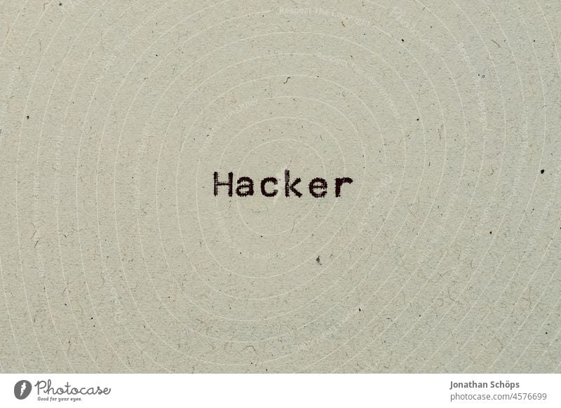 Hacker as text on paper with typewriter Computer hacker Cybercrime Paper Recycling Typewriter writing typography Analog Chop Retro Text Copy Space vintage
