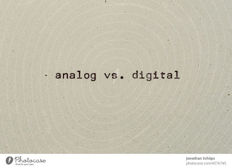analog vs digital as text on paper with typewriter Disadvantages Paper Recycling Typewriter writing typography Advantages Disagreement Analog both Digital Retro