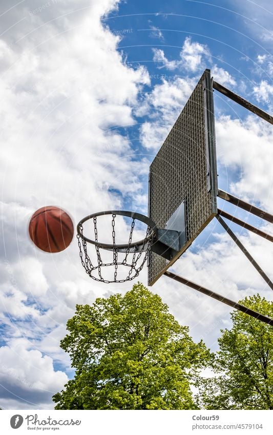 Playing Basketball leisure basket game hoop sky outside sport basketball play competition high net goal recreation background score win team court blue street