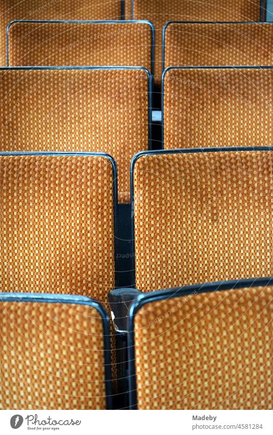 Old cinema chairs as cinema seating with fabric cover in the style and colors of the seventies in an old factory hall with antiques in the district Margaretenhütte in Giessen on the Lahn in Hesse