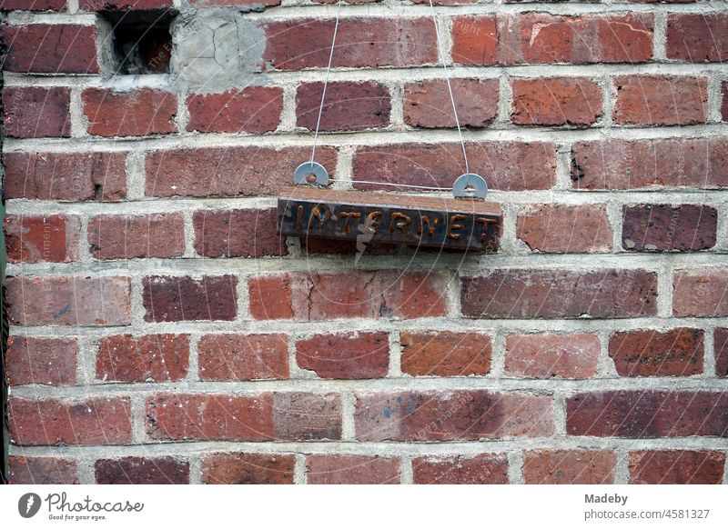 Rusty sign to the internet in front of an old factory wall made of red brick in the district Margaretenhütte in Gießen at the river Lahn in Hesse, Germany