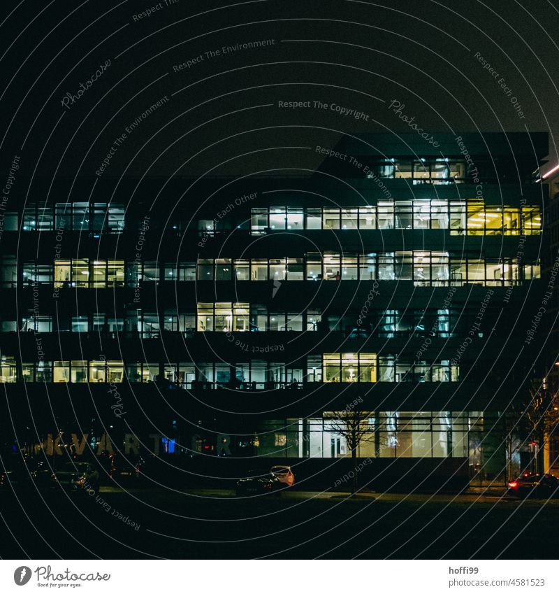 illuminated office building in the evening Office work Facade Illuminated Window Dark Observe Cliche Business Closing time High-rise Bank building Desk