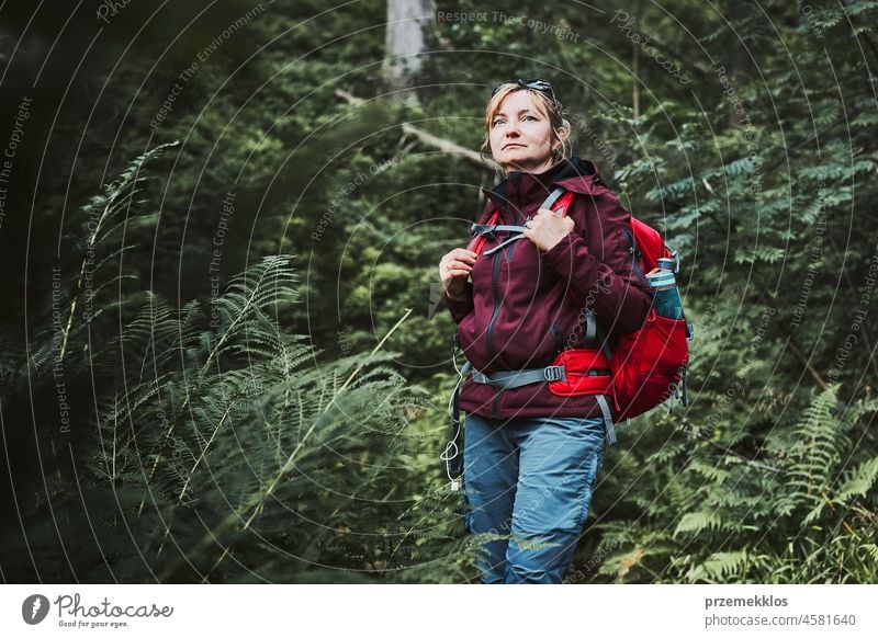 Woman with backpack hiking in forest, actively spending summer vacation close to nature adventure trip travel journey trekking woman mountain wanderlust walking
