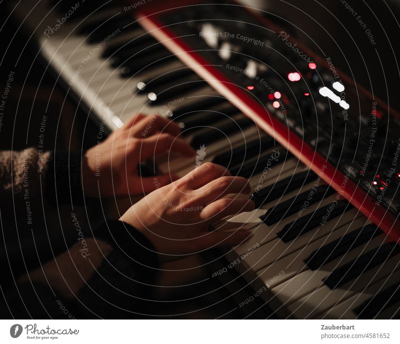 Girl playing red keyboard at night, hands on keyboard Hand Keyboard songwriting fumble Red Buttons Controller Music Playing play music Musical instrument