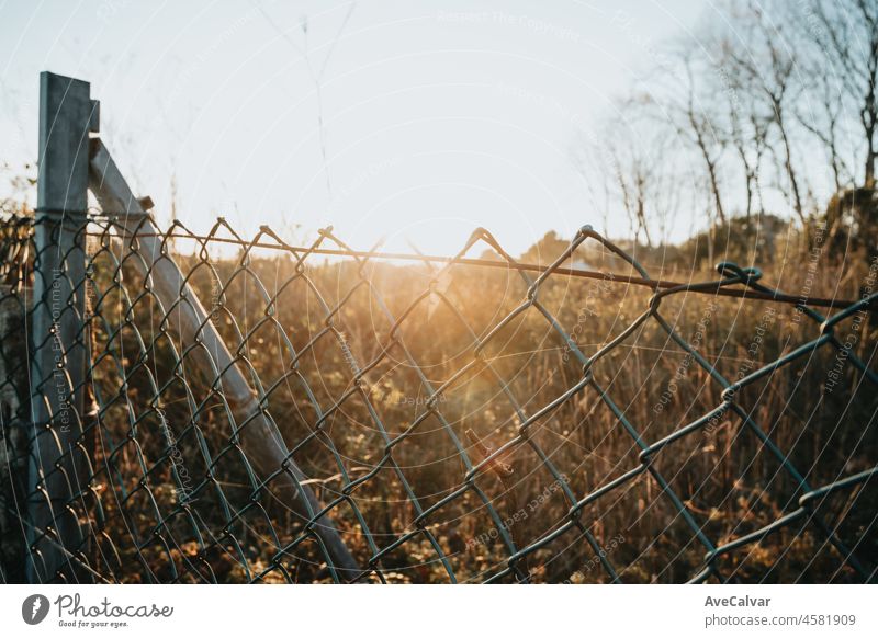 Moody sunset over a fence background to add inspirational text. Minimal image with copy space. Wallpaper sunny sunlight field nature sky landscape natural view